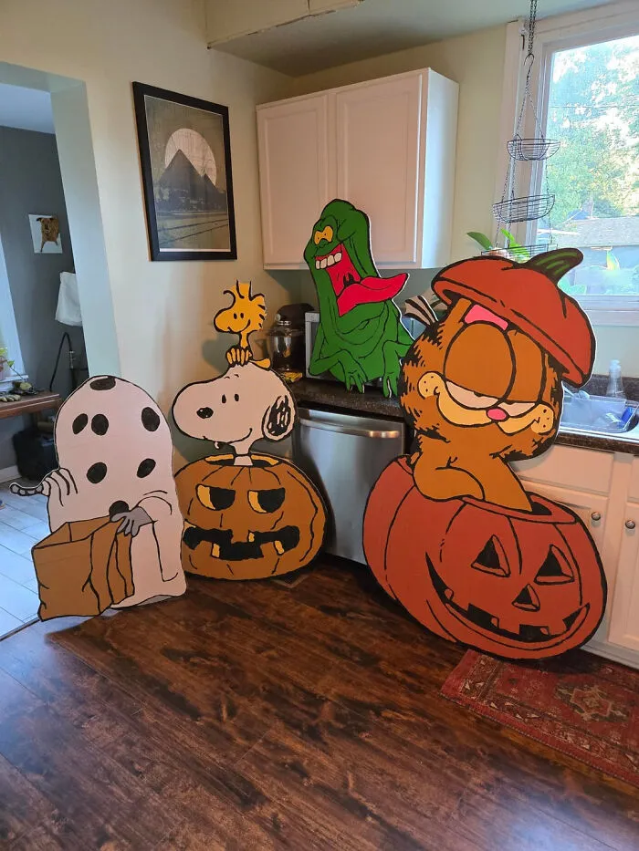 Nostalgic cartoon character cutouts displayed in a kitchen for Halloween.