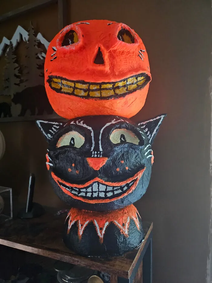 Paper mache black cat and pumpkin decoration for Halloween homes.