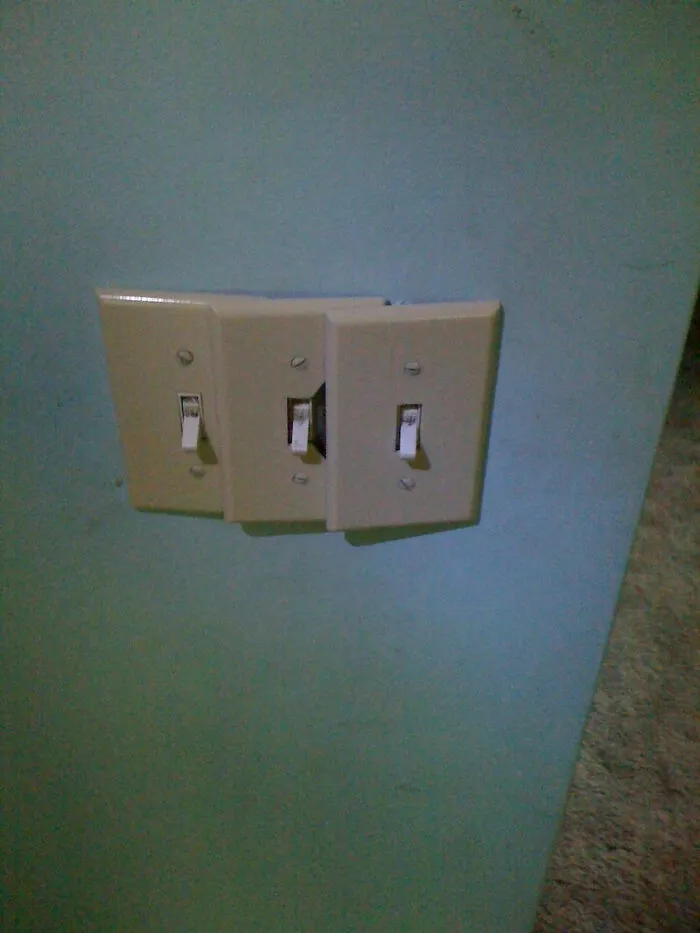 Three misaligned light switches overlapping each other on a wall, depicting a failed plan to improve their homes.