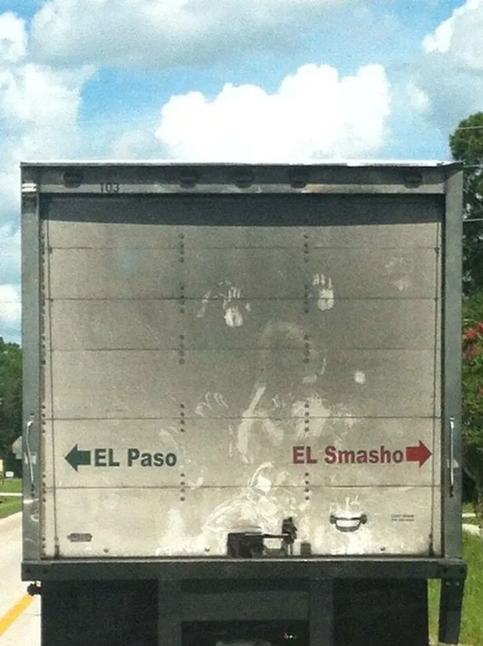 Back of a cargo truck with hilarious EL Paso and EL Smasho directional arrows.
