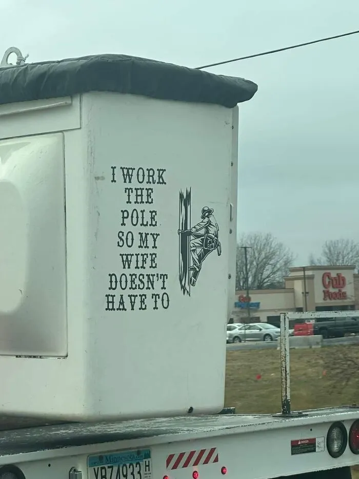 A utility truck bucket with a funny sticker reading I work the pole so my wife does not have to.