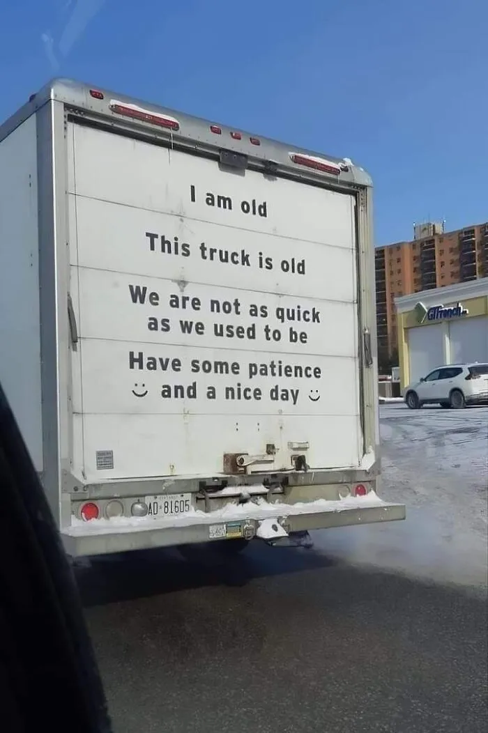 Back of a delivery truck with a polite and funny message asking drivers to have patience