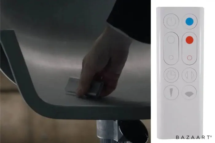 A hand placing a white remote control on a chair, showcasing clever movie props.