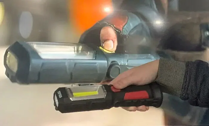 Comparison of sci-fi blaster prop and everyday hand-held work light used as movie props.