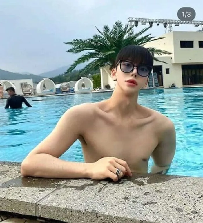Ridiculously edited photo of shirtless man with slim neck and large sunglasses by pool