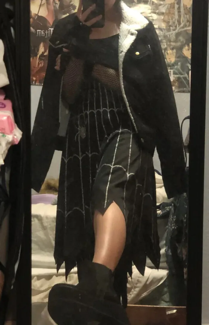 A person wearing a spider web skirt as part of creative Halloween costume ideas.