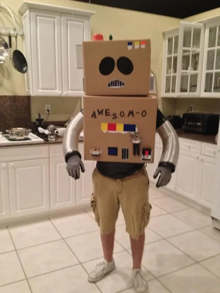 Person wearing a homemade AWESOM-O cardboard robot suit as a funny Halloween costume idea.