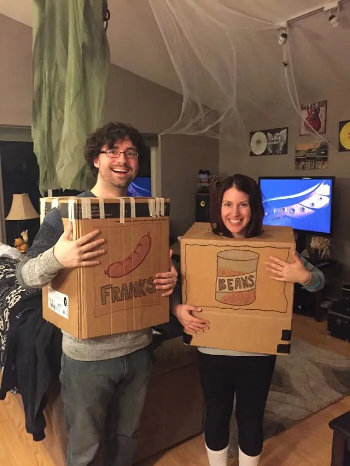 Couple in DIY cardboard boxes labeled Franks and Beans for a creative Halloween costume idea