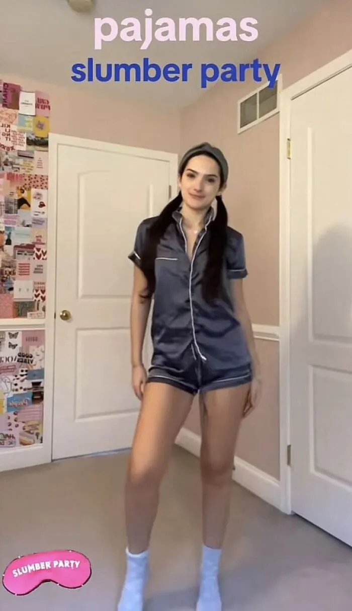 A woman posing in silk pajamas for an easy slumber party Halloween costume idea.