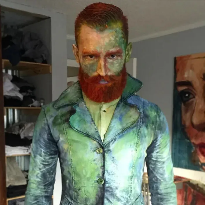 A man dressed as Vincent van Gogh with painted face and jacket for a Halloween costume idea.