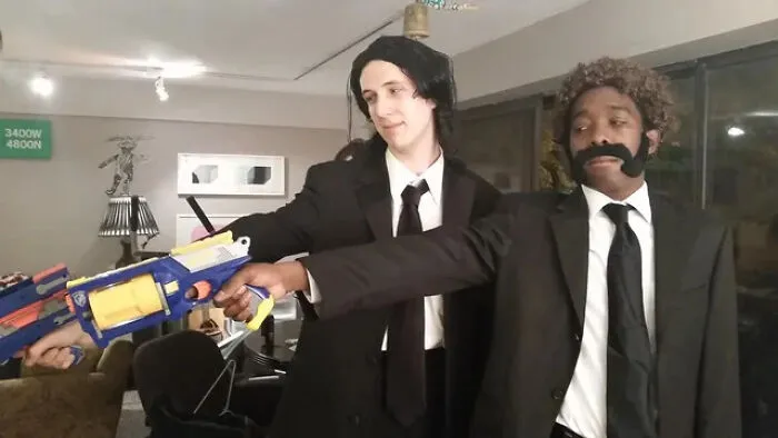 Two men dressed as Pulp Fiction characters holding toy guns, a creative last-minute Halloween costume idea.