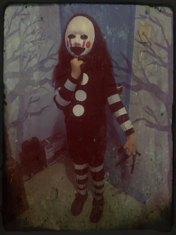 Spooky child wearing a Puppet mask, showing off a last-minute homemade Halloween costume idea.