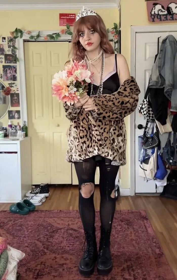 A woman wearing a tiara, leopard print coat, and ripped tights for Halloween costume ideas.
