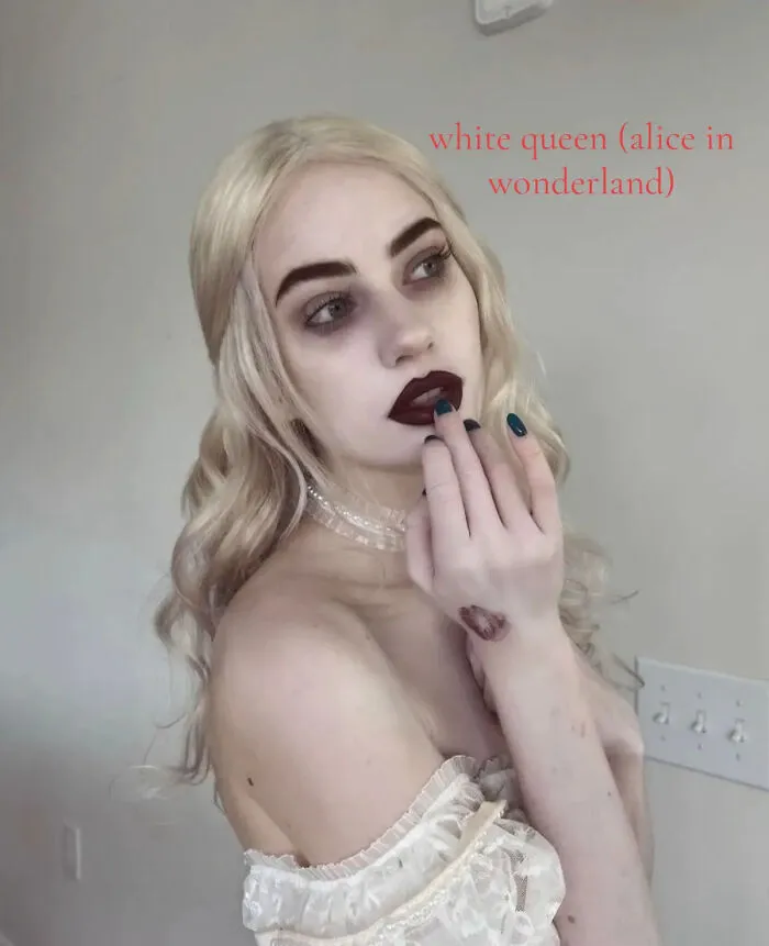 Woman in pale makeup dressed as the White Queen for dramatic Halloween costume ideas.