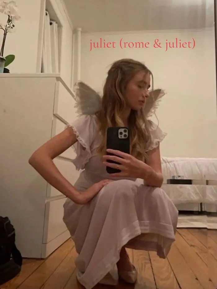 Woman posing with angel wings dressed as Juliet for last minute Halloween costume ideas.