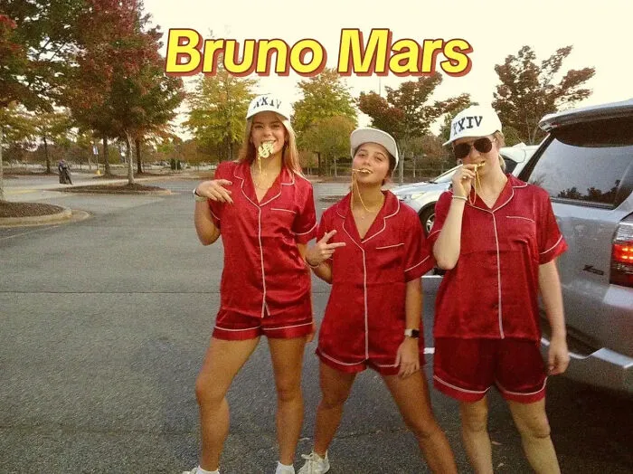 Three women wearing matching red silk pajamas for a Bruno Mars Halloween costume idea