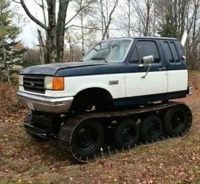 A modified pickup truck cabin mounted on tank tracks, an example of bold Slavic engineering.
