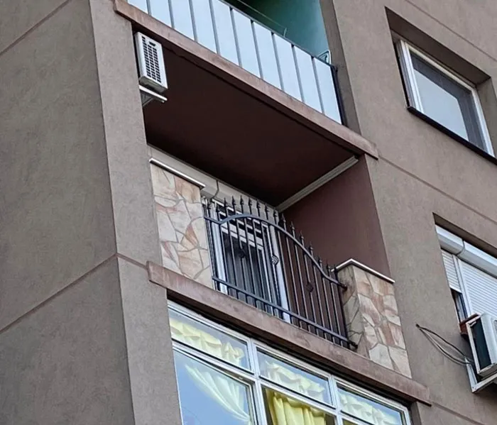 An unusually small balcony with a tiny gate representing unique Slavic engineering.