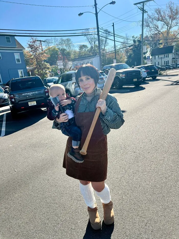 Woman holding a baby in matching Wendy and Danny Torrance creative Halloween costume ideas