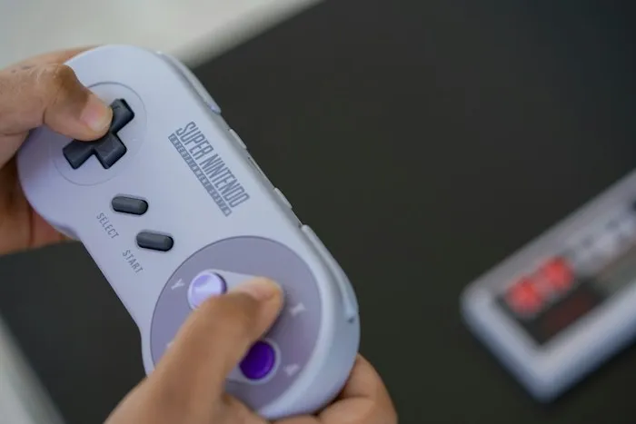 Person holding a retro video game controller as a dumpster finds treasure