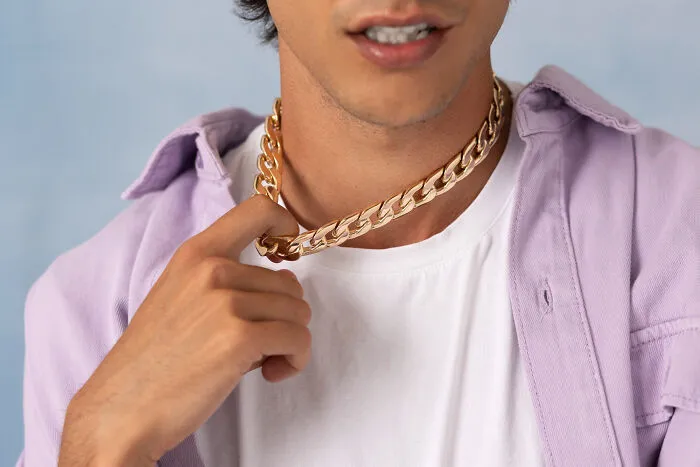Man wearing gold chain necklace discovered among valuable dumpster finds.
