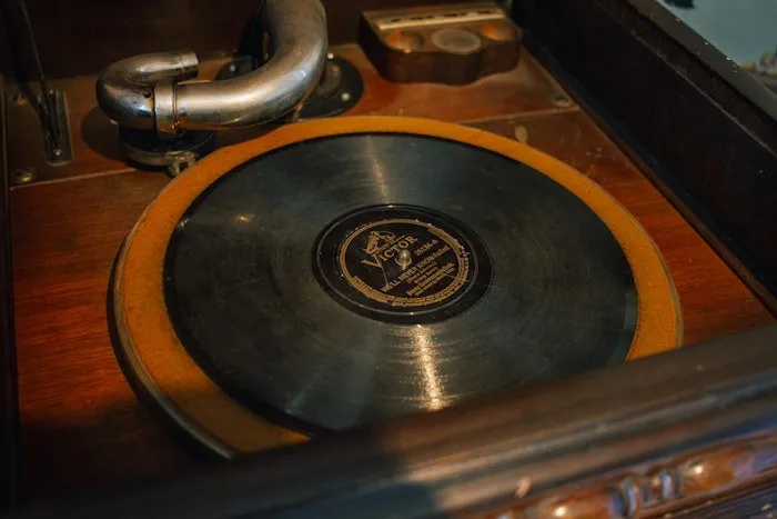 A vintage Victor vinyl record playing on a wooden record player, a rare treasure among dumpster finds.
