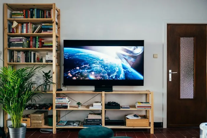 Large flat screen TV on a wooden console table, one of the best dumpster finds.