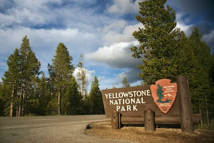 A sign for Yellowstone National Park, illustrating real places subject to unusual laws and loopholes.