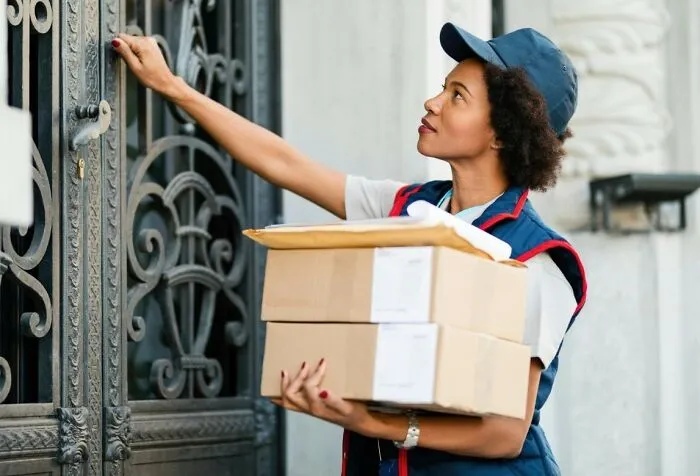Delivery worker carrying packages illustrating legal loopholes and postal rules