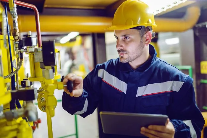 A technician inspecting machinery, cautious of any single slip-up on the job