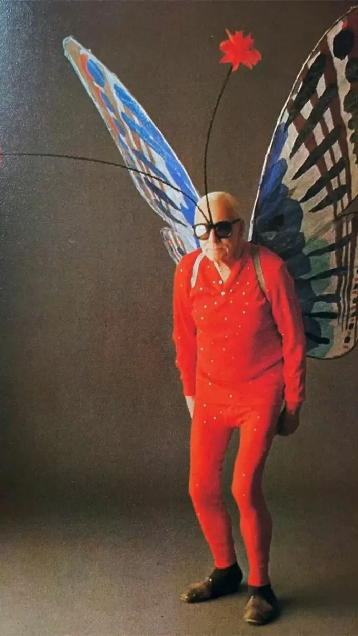 Older man wearing a red suit with giant butterfly wings as a creative Halloween costume idea