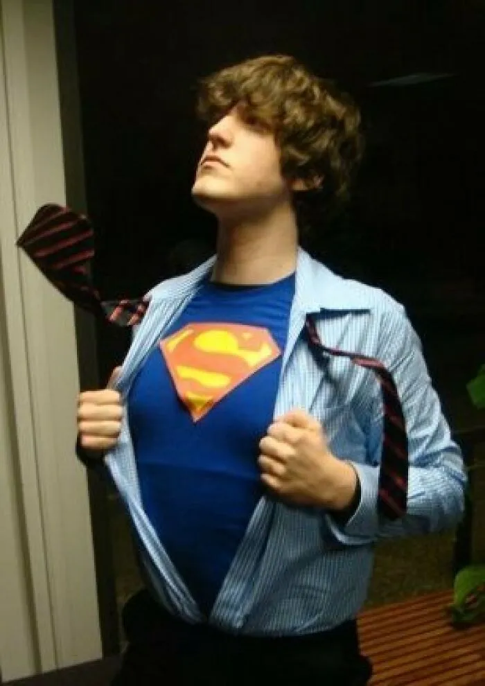 Man opening his dress shirt to reveal a Superman shirt for a creative Halloween costume idea