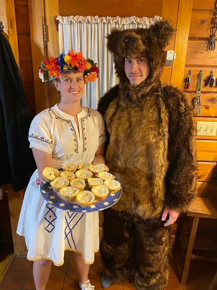 A couple in Midsommar inspired Halloween costume ideas with floral crown and bear suit