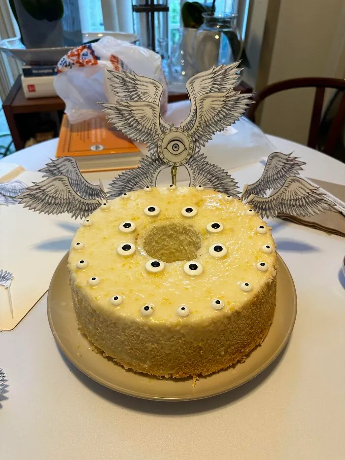 Eerie angel-themed ring cake decorated with candy eyes as spooky Halloween foods.