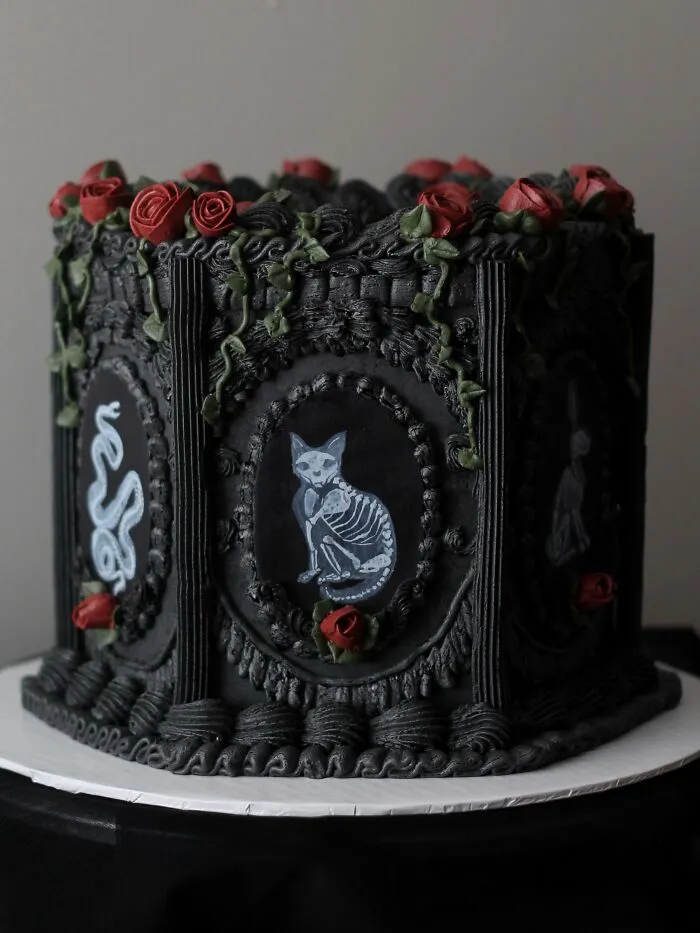 Ornate black gothic cake featuring skeleton cat art as unique Halloween foods