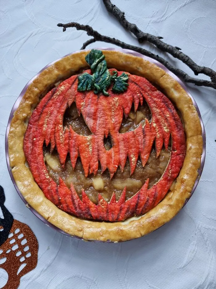 Homemade pie with a scary jack-o-lantern face crust as spooky Halloween foods