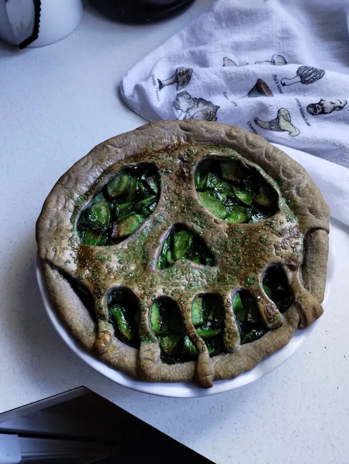 Baked fruit pie featuring a spooky melting skull crust for creative Halloween foods.