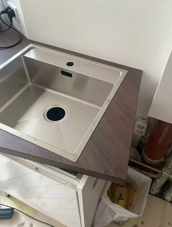 An awkwardly fitted kitchen sink showing a home improvement layout fiasco.