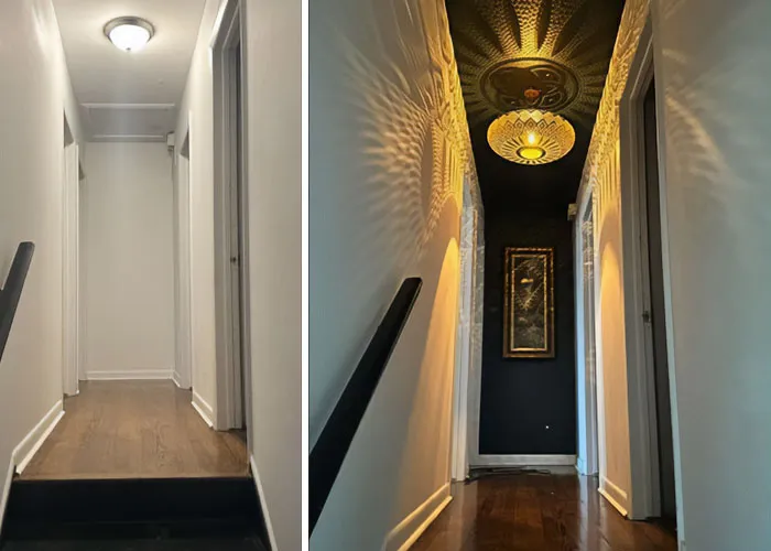 Hallway home makeover featuring a patterned light fixture and dark accent wall