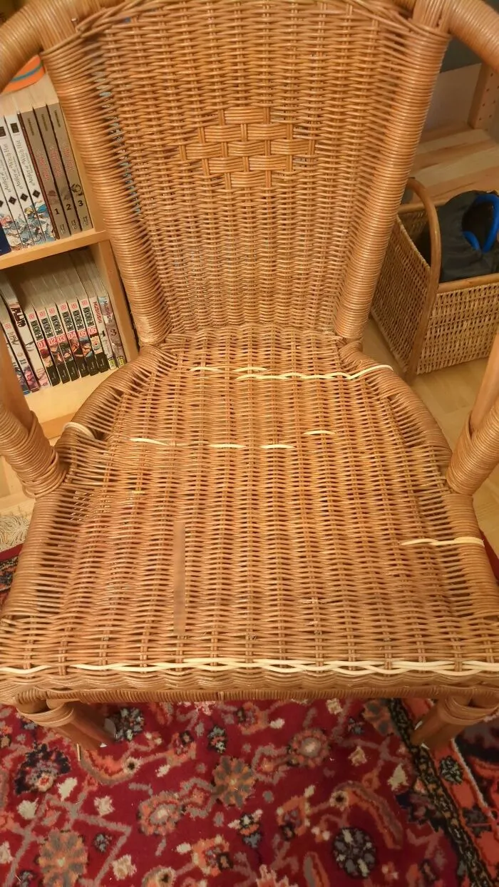 Wicker chair fixed with woven plastic strips, a smart display of creativity to save money on furniture.