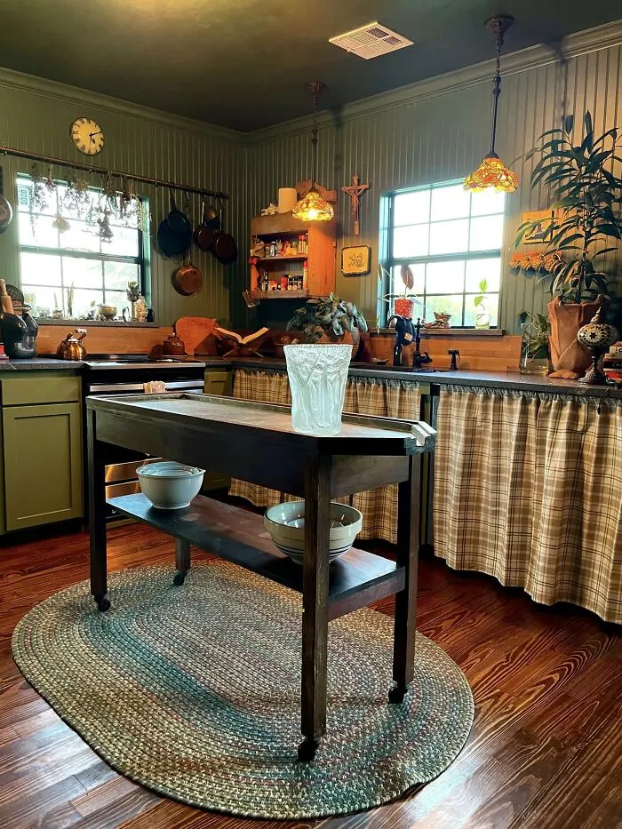 Rustic kitchen with green walls and wooden island showing creative home makeover ideas