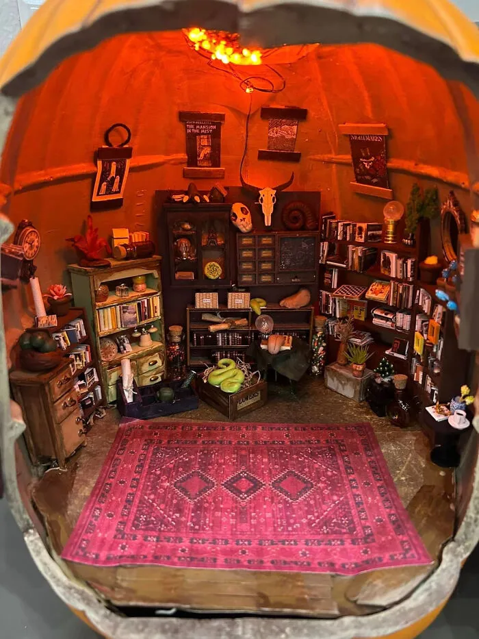 Miniature haunted witch library diorama inside a pumpkin home decorated for Halloween