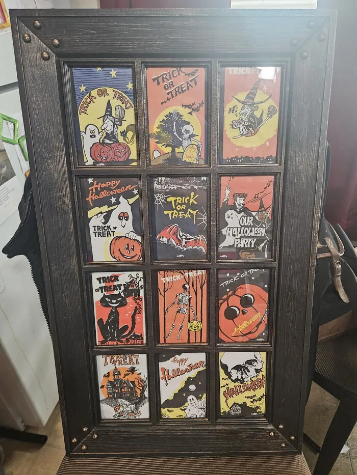 Framed vintage Halloween cards and trick or treat art display on a wall
