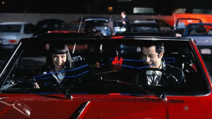 Mia Wallace and Vincent Vega in a red convertible, memorable movie props from Pulp Fiction