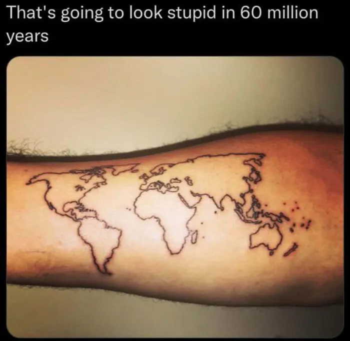 Arm tattoo of a world map with text about looking stupid in 60 million years