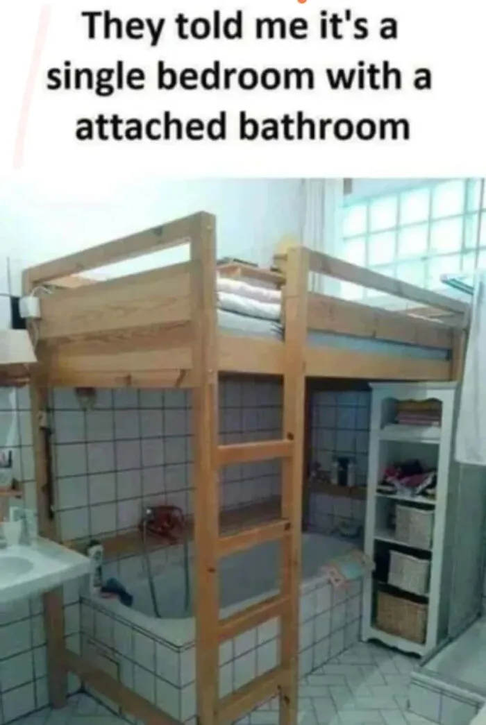 Loft bed built over a tiled bathtub with text about single bedroom with attached bathroom