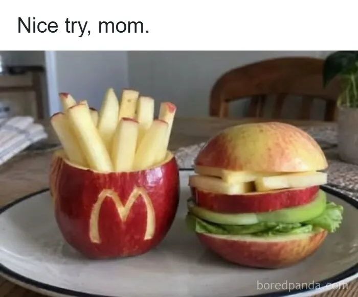 Odd photo of apples carved to look like a fast food meal with fries and a burger.