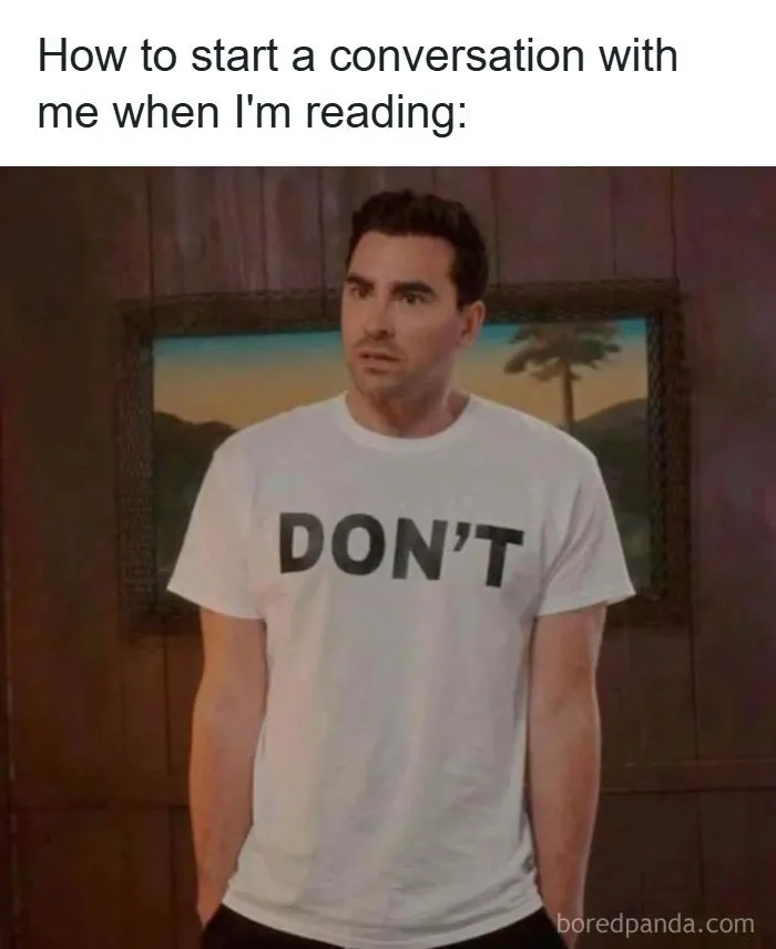 Man wearing dont t-shirt with text about starting conversation while reading