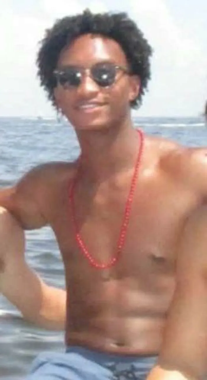 A young man wearing sunglasses on a boat, captured in photos during vacation.