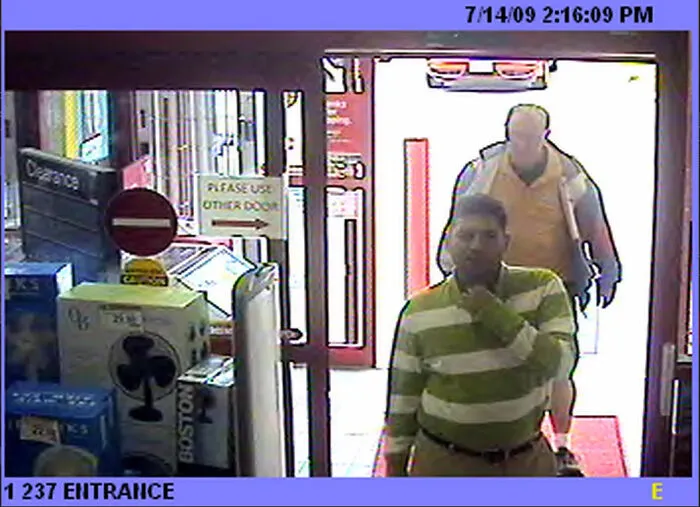 Security camera footage showing a person captured in photos at a store entrance.